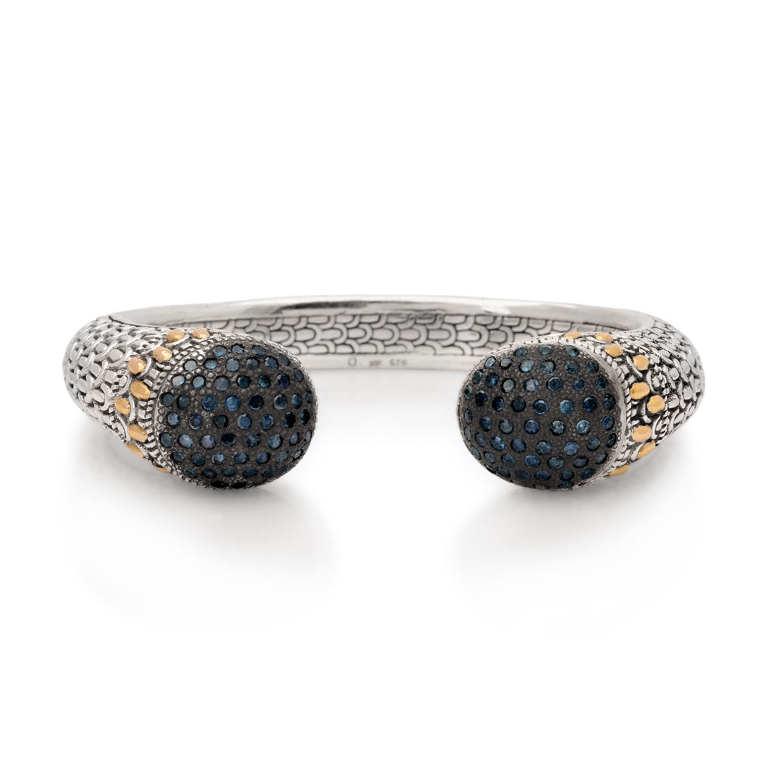 Silver bangle bracelet with blue diamonds on the ends