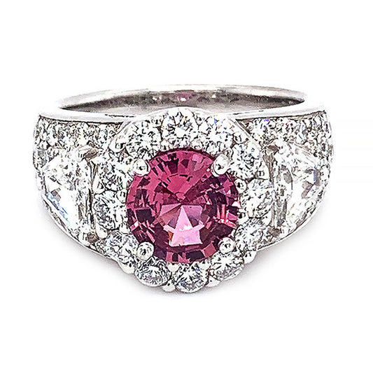 Platinum engagement ring with pink sapphire center and diamonds